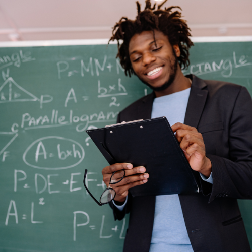 Teacher in front of black board with math equations